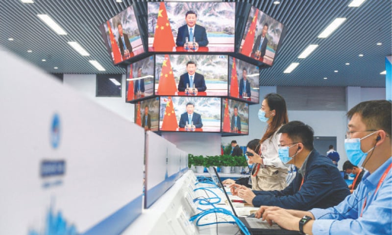 Media staff work next to screens showing live images of China&rsquo;s President Xi Jinping speaking during the opening ceremony of the China International Import Expo (CIIE) at the media centre of the CIIE in Shanghai last year. China&rsquo;s President Xi Jinping is widely expected to secure a third term as president at the Chinese Communist Party congress meeting starting on October 16, 2022, upending the succession norms that Chinese leaders have abided by since the 1990s.&mdash;AFP