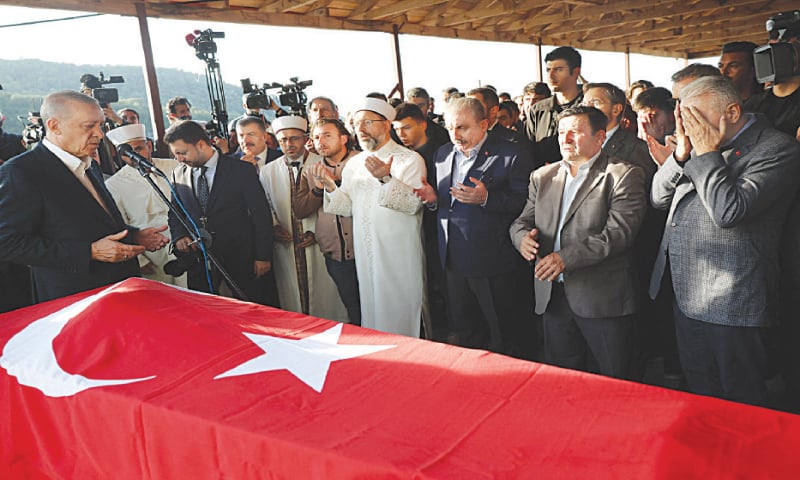 Turkish President Recep Tayyip Erdogan prays at the funeral of a man who was killed in the coal mine blast.&mdash;AFP