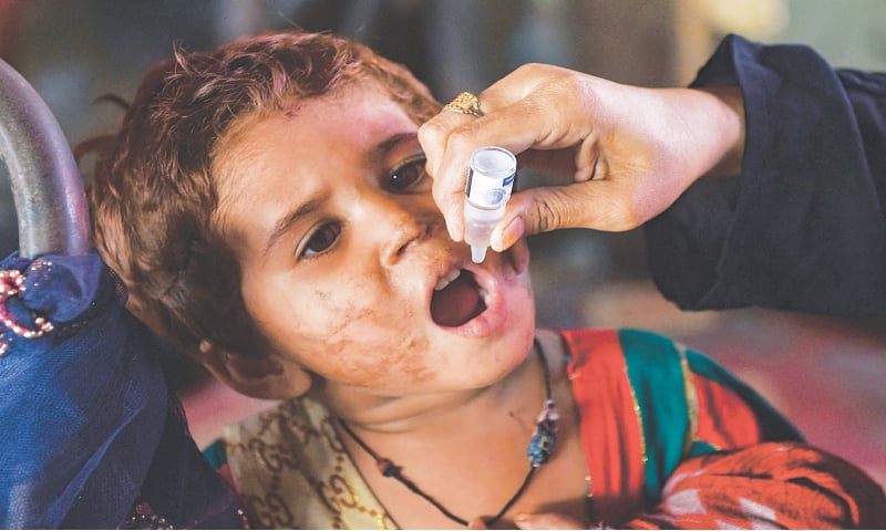 A child is being administered polio drops in Karachi on Monday.—AFP