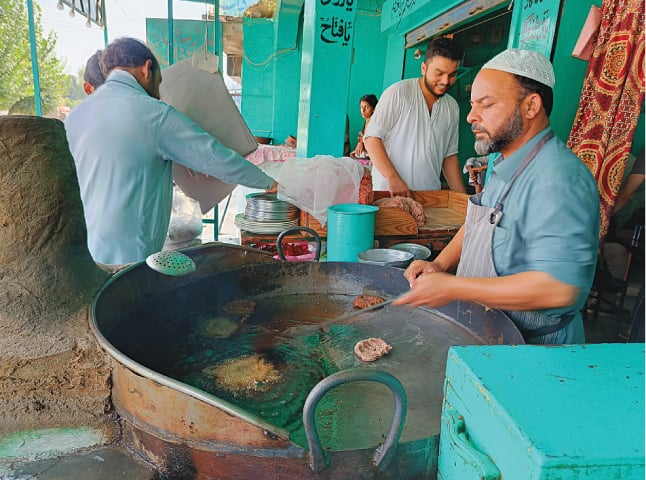 Khaista Khan preparing chapli kebabs for a customer