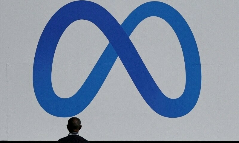 A man stands in front of a sign of Meta at its headquarters in Menlo Park, California, US, October 28, 2021. &mdash; Reuters/File