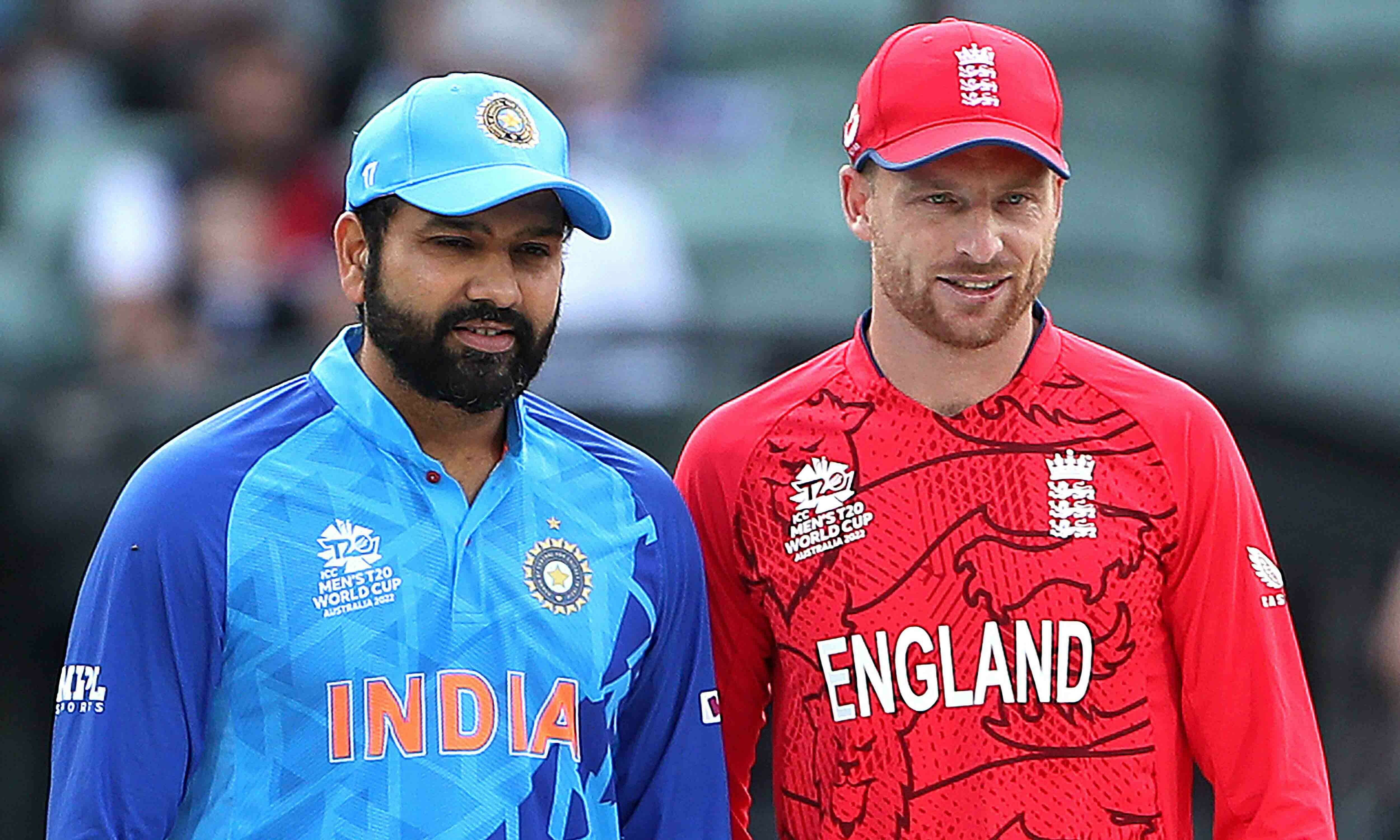 Captain Rohit Sharma (L) poses for pictures with England’s Captain Jos Buttler at the toss during the ICC men’s Twenty20 World Cup 2022 semi-final cricket match between England and India at The Adelaide Oval on November 10, 2022 in Adelaide. — AFP