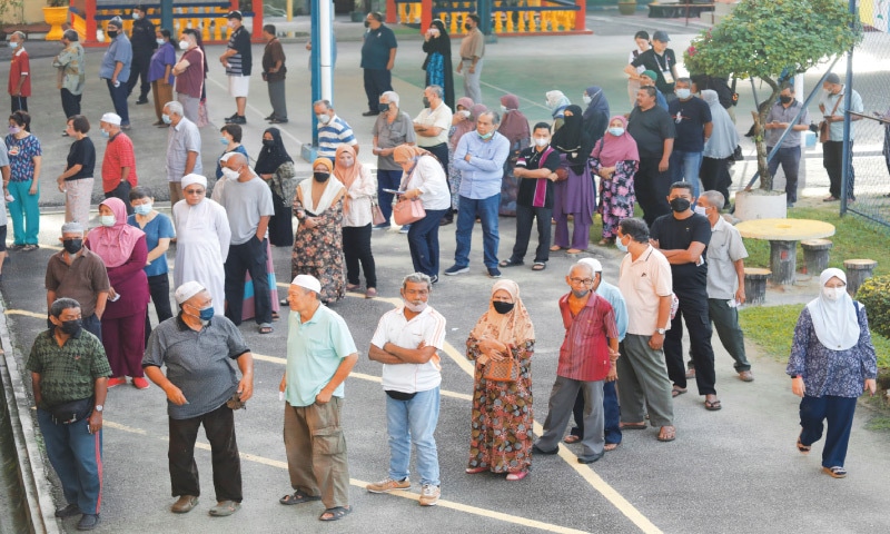 Penang (Malaysia): People queue to cast their vote during the country’s general election at Permatang Pauh on Saturday.—Reuters