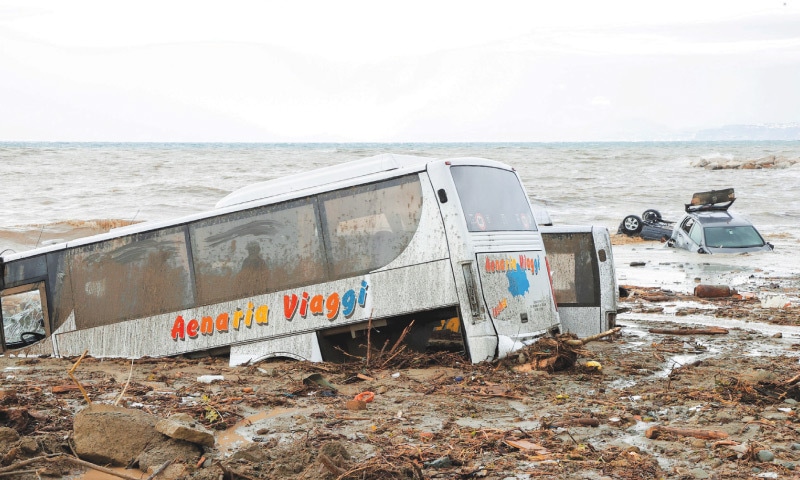 Damaged cars are seen by the sea following a landslide on the Italian holiday island of Ischia on Saturday.—Reuters Damaged cars are seen by the sea following a landslide on the Italian holiday island of Ischia on Saturday.—Reuters