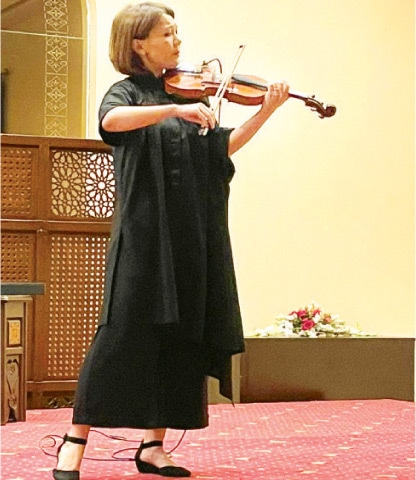 Violinist Fatima Rakisheva performs at a concerto in Islamabad on Sunday. — Dawn