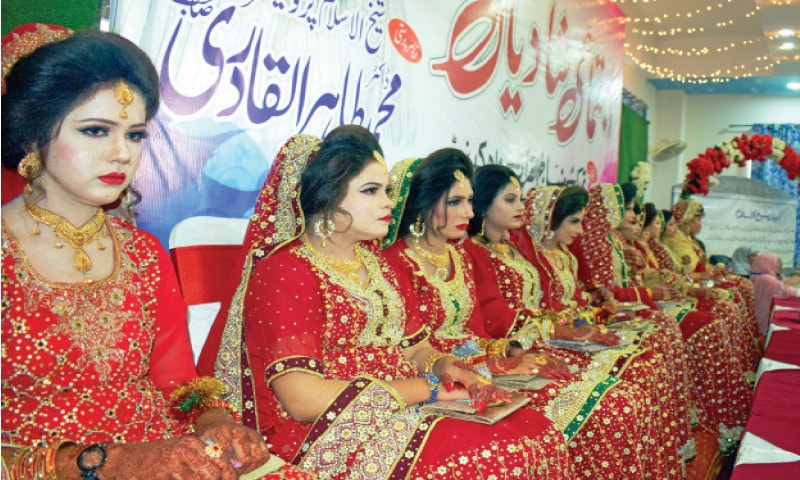 Brides sit on stage during the mass wedding ceremony near Wah on Sunday. — Dawn