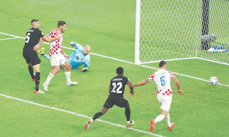 DOHA: Croatia’s Andrej Kramaric (L) scores during the Group ‘F’ match against Canada at the Khalifa International Stadium on Sunday.—Reuters