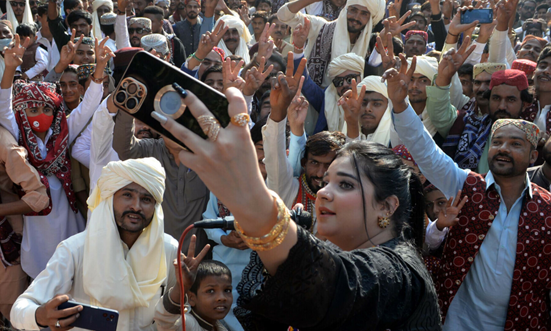 A woman takes a selfie outside the Hyderabad Press Club amid Sindh Culture Day celebrations on Sunday. — Umair Ali