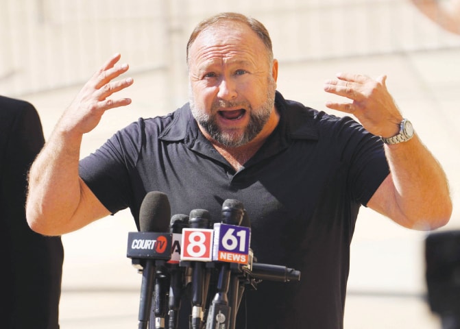 In this file photo taken on Sept 21, InfoWars founder Alex Jones speaks to the media outside a court in Waterbury, Connecticut.—AFP In this file photo taken on Sept 21, InfoWars founder Alex Jones speaks to the media outside a court in Waterbury, Connecticut.—AFP