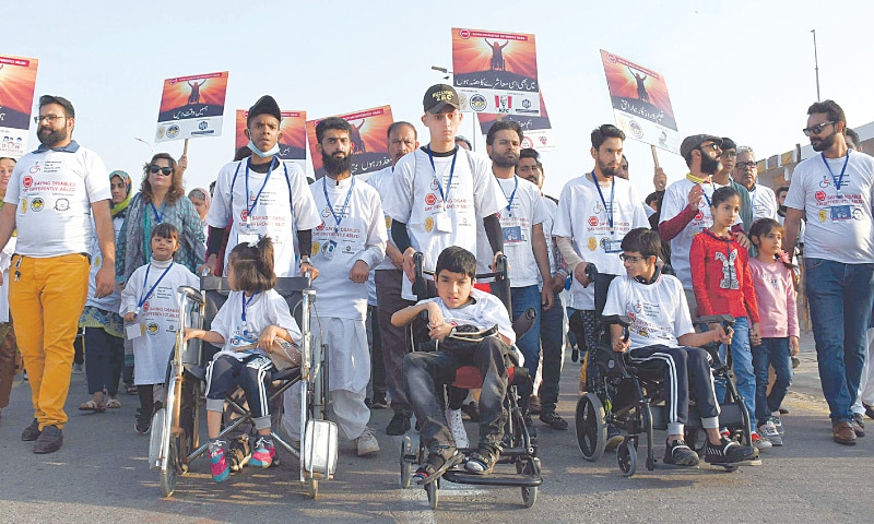 Men, women and children of all ages take part in an awareness walk to mark International Day of Persons With Disabilities on Saturday.&mdash;Online