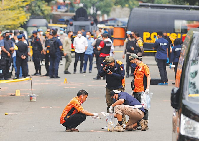 Bandung (Indonesia): Security officials use an automatic fingerprint identification system to carry out investigations after a blast at a police station on Wednesday.—Reuters