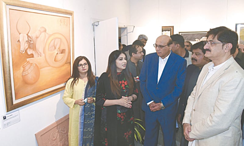 Sindh Chief Minister Murad Ali Shah admires a painting at the exhibition.