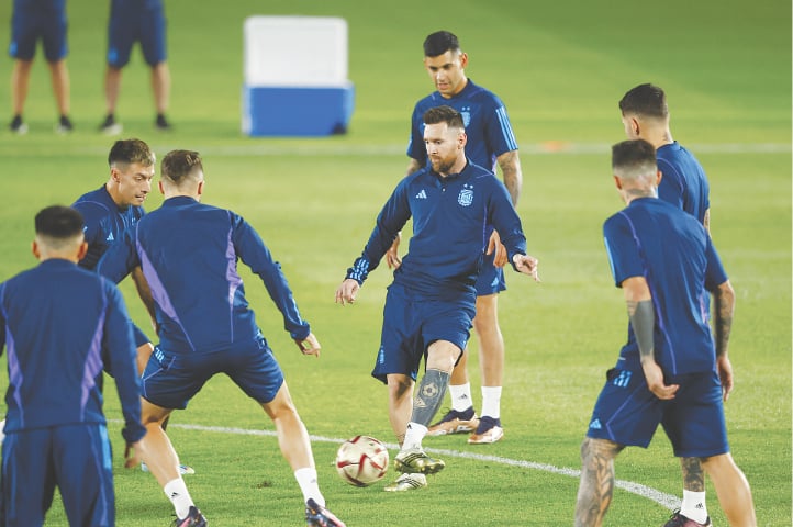 Argentina's Lionel Messi (C), Lisandro Martinez (second L), Cristian Romero (third R) and other team-mates practise at the Qatar University Training Site 3 on Monday.&mdash;Reuters