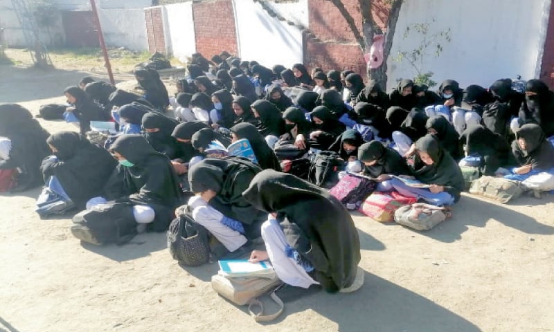 Students attend a class under the open sky. &mdash; Dawn