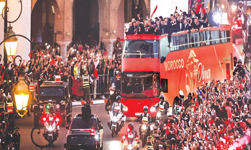 Supporters cheer as Morocco&rsquo;s national football team arrives to the center of the capital.&mdash;AFP