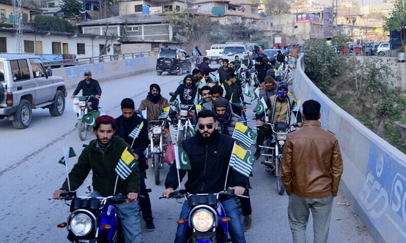Participants of a motorcycle and car rally pass through a bridge on western bypass in Muzaffarabad to mark Right to Self Determination Day on Thursday.&mdash;Photo by author