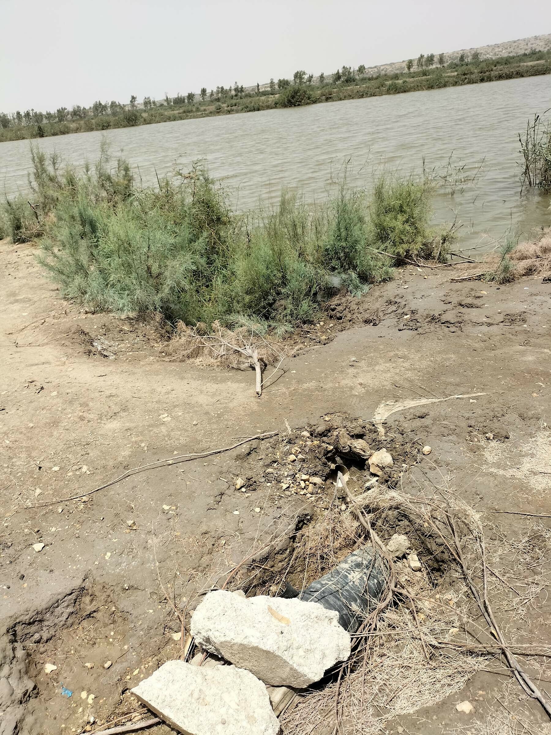 Pipe, partially hidden by rocks, drawing water meant for Karachi from Keenjhar-
Gujjo canal to sustain the fish farms in the area.