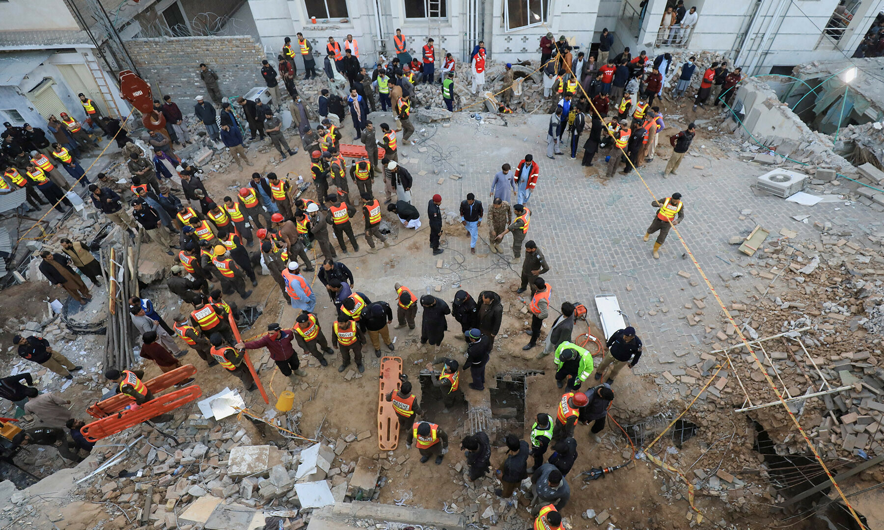 Rescue workers gather to remove the rubble to look for survivors, after a suicide blast in a mosque in Peshawar on January 30, 2023. — Reuters/Fayaz Aziz