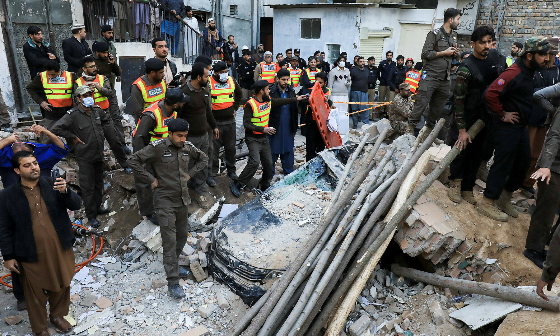 People and rescue workers gather amid the damages, after a suicide blast in a mosque in Peshawar on January 30, 2023. — Reuters/Fayaz Aziz