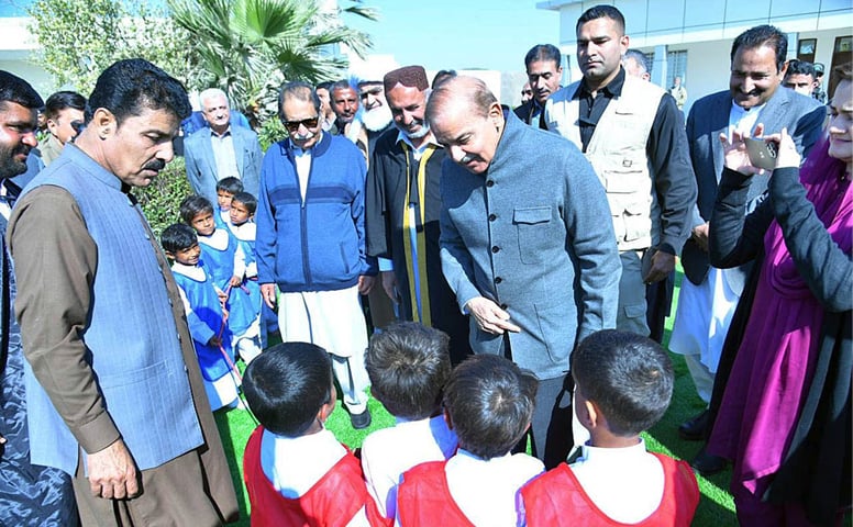 SOHBATPUR: Prime Minister Shehbaz Sharif interacts with students after inaugurating the new building of Government Boys Secondary School on Wednesday.—APP