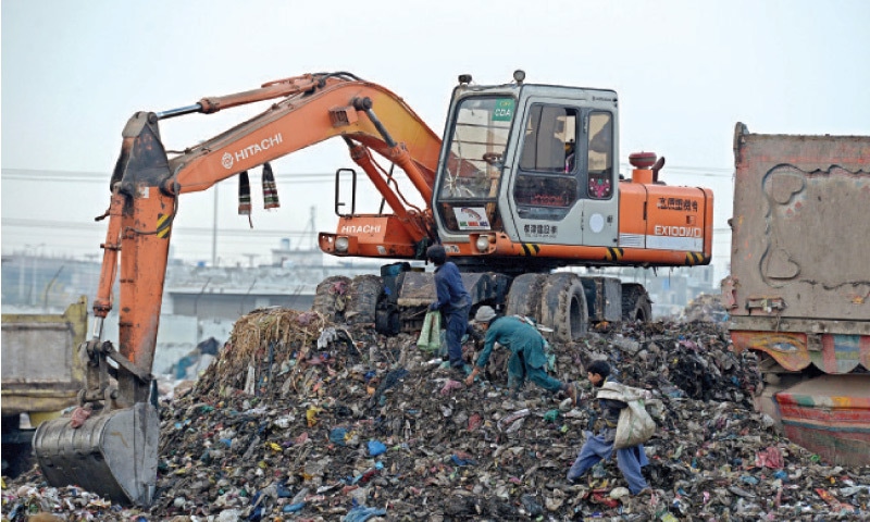 Ragpickers look for recyclable items from a garbage dump in Islamabad’s I-11 area. — Photo by Mohammad Asim Ragpickers look for recyclable items from a garbage dump in Islamabad’s I-11 area. — Photo by Mohammad Asim