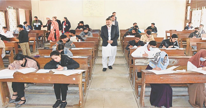 Candidates take their pre-admission test at a centre in Karachi University on Sunday.—PPI Candidates take their pre-admission test at a centre in Karachi University on Sunday.—PPI