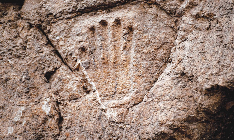 A handout picture provided by the Israel Antiquities Authority shows a hand imprint that was discovered carved into a 1,000-year-old dry moat which surrounded Jerusalem’s old quarter.—AFP