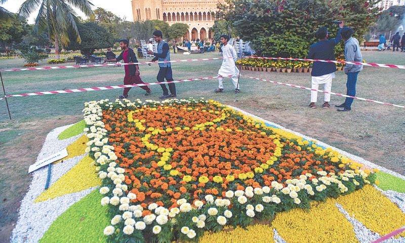 Visitors admire a display of marigolds at Frere Hall lawns on Friday.&mdash;Fahim Siddiqi / White Star