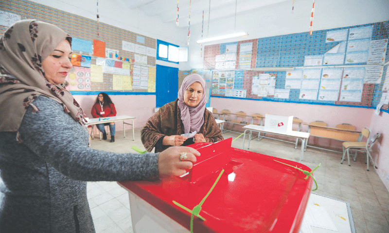 Tunis: A voter prepares to cast her ballot at a polling station during the second round of parliamentary elections on Sunday.&mdash;Reuters