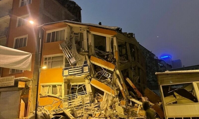 A man walks past by a collapsed building after an earthquake in Malatya, Turkiye, February 6. — Reuters A man walks past by a collapsed building after an earthquake in Malatya, Turkiye, February 6. — Reuters