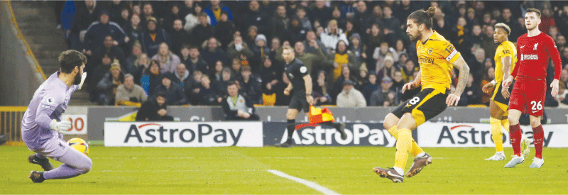 WOVERHAMPTON: Wolverhampton Wanderers&rsquo; Ruben Neves scores past Liverpool goalkeeper Alisson (L) during their Premier League match at the Molineux.&mdash;Reuters