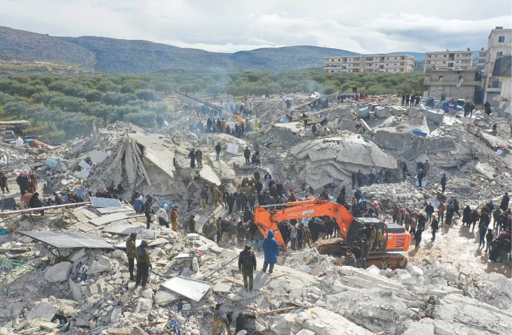 Harim (Syria): An aerial view shows residents searching for victims and survivors amidst the rubble of collapsed buildings following an earthquake in the village of Besnia in Syria’s northwestern Idlib province, on the border with Turkiye, on Monday. Thousands were reportedly killed by a 7.8-magnitude earthquake that originated in Turkiye.—AFP