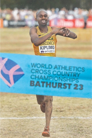 BATHURST: Uganda’s Jacob Kiplimo celebrates before crossing the finish line to win the men’s race of the World Cross Country Championships at Mount Panorama on Saturday. —AFP