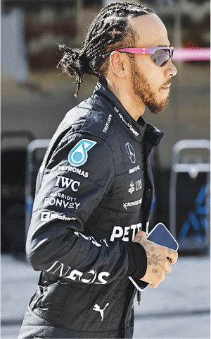 SAKHIR: Mercedes&rsquo; Lewis Hamilton walks in the pits during Formula One&rsquo;s pre-season testing at the Bahrain International Circuit on Friday.&mdash;Reuters