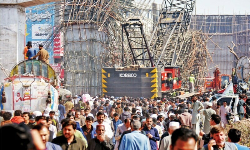 In this file photo, people gather at the site of the under-construction Bhara Kahu flyover after its transom collapsed on February 25, claiming two lives. — Photo by Tanveer Shahzad In this file photo, people gather at the site of the under-construction Bhara Kahu flyover after its transom collapsed on February 25, claiming two lives. — Photo by Tanveer Shahzad