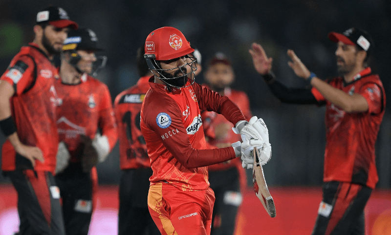 Islamabad United’s captain Shadab Khan (C) walks off the pitch after his dismissal by Lahore Qalandars’ Rashid Khan (not pictured) during the Pakistan Super League (PSL) T20 cricket match between Islamabad United and Lahore Qalandars at the Rawalpindi Cricket Stadium, in Rawalpindi on March 9, 2023. — AFP