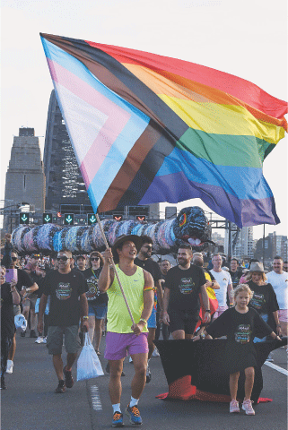 People participate in the Pride March event over the Harbour Bridge in Sydney on Sunday.&mdash;AFP