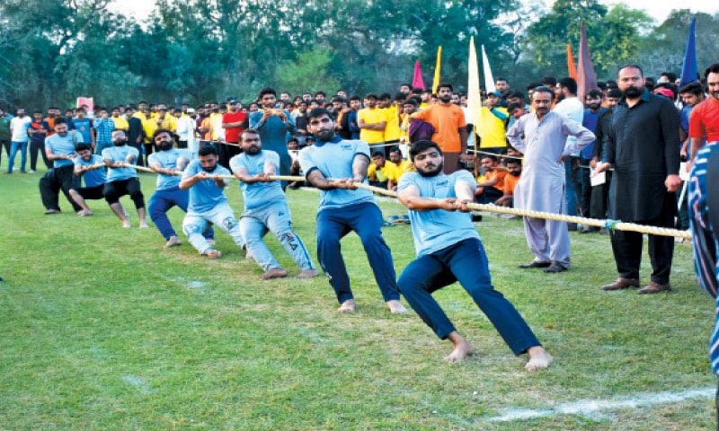Faisalabad: Students take part in a tug of war contest at the UAF. &mdash; Dawn