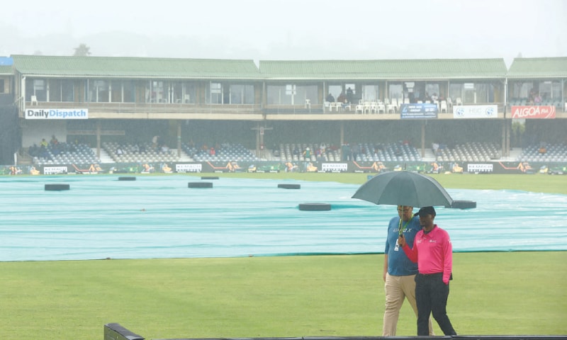 EAST LONDON: Umpire Bongani Jele holds an umbrella after inspecting the pitch before the first ODI between South Africa and West Indies is called off due to rain on Thursday.&mdash;Reuters