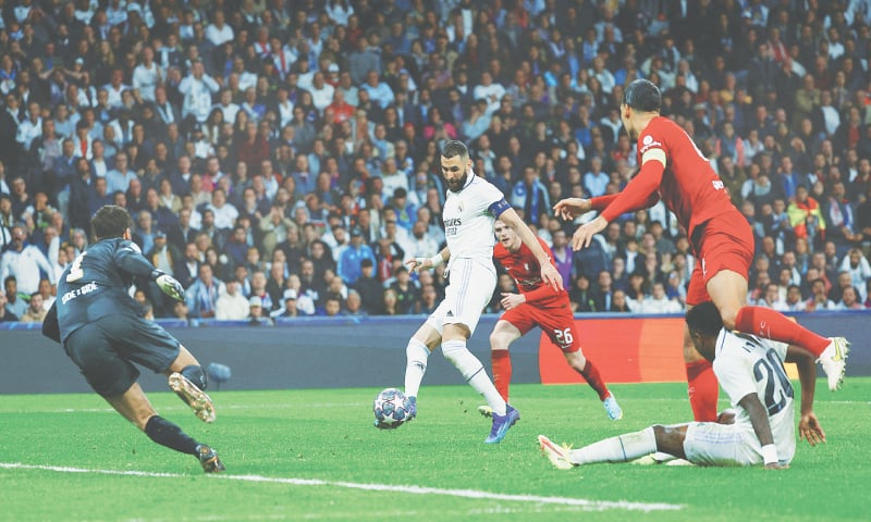 MADRID: Real Madrid’s Karim Benzema (C) shoots to score past Liverpool goalkeeper Alisson Becker during their Champions League round-of-16 second leg at Santiago Bernabeu.—Reuters MADRID: Real Madrid’s Karim Benzema (C) shoots to score past Liverpool goalkeeper Alisson Becker during their Champions League round-of-16 second leg at Santiago Bernabeu.—Reuters