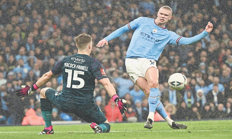 MANCHESTER: Manchester City’s Erling Haaland scores past Burnley goalkeeper Bailey 
Peacock-Farrell during their FA Cup quarter-final at the Etihad Stadium.—AFP