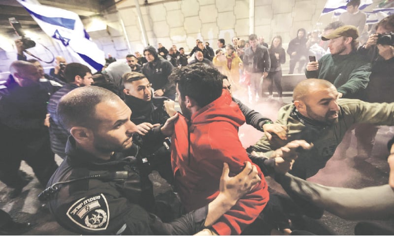 Protesters scuffle with Israeli forces during a rally in Tel Aviv against the government’s controversial judicial overhaul bill.—AFP Protesters scuffle with Israeli forces during a rally in Tel Aviv against the government’s controversial judicial overhaul bill.—AFP