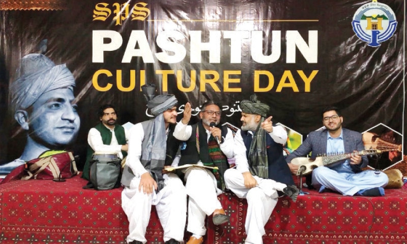 Students and teachers present a folk song during the festival in Swat. — Dawn