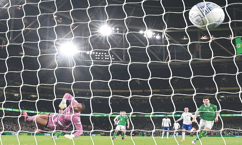 DUBLIN: France’s Benjamin Pavard (not pictured) scores past Ireland goalkeeper Gavin Bazunu during their Euro 2024 group ‘B’ qualifier at the Aviva Stadium.—AFP