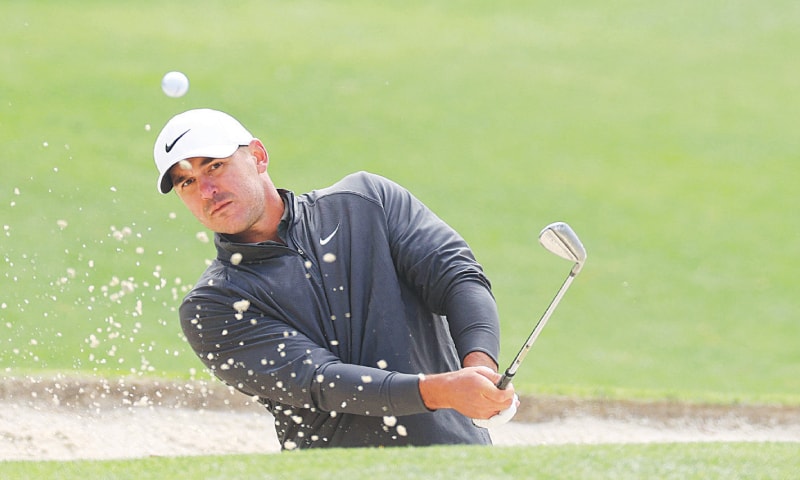BROOKS Koepka of the US plays a shot from a bunker on the 17th hole during the continuation of the weather-delayed third round of the Masters Tournament at the Augusta National Golf Club on Sunday.—AFP BROOKS Koepka of the US plays a shot from a bunker on the 17th hole during the continuation of the weather-delayed third round of the Masters Tournament at the Augusta National Golf Club on Sunday.—AFP