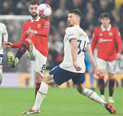 LONDON: Manchester United’s Bruno Fernandes (L) passes the ball under pressure from Tottenham Hotspur’s Clement Lenglet during their Premier League match at the Tottenham Hotspur Stadium.—AFP