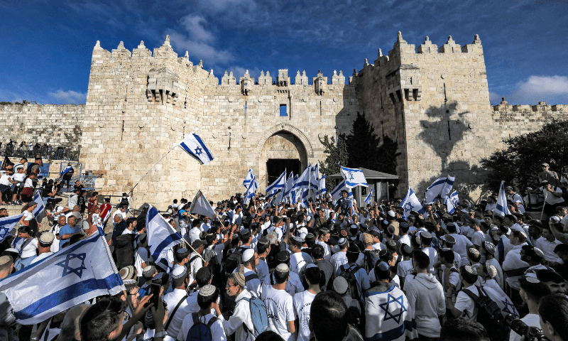 Demonstrators waving Israeli flags gather outside the Damascus Gate of the Old City of Jerusalem during the annual &lsquo;flag march&rsquo; to mark &lsquo;Jerusalem Day&rsquo; on May 18, 2023. &mdash; AFP