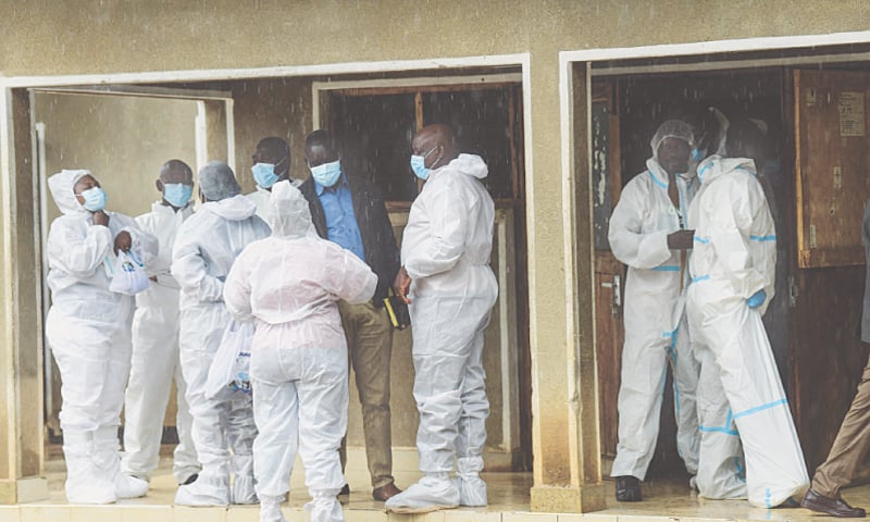 Kenyan officials and pathologists, wearing protective clothing, stand by before the start of postmortem analysis on victims of the Shakahola massacre at a funeral home on Monday.—AFP Kenyan officials and pathologists, wearing protective clothing, stand by before the start of postmortem analysis on victims of the Shakahola massacre at a funeral home on Monday.—AFP