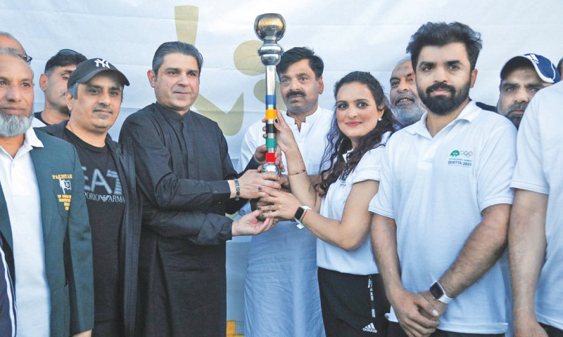 ISLAMABAD: Federal Minister for Inter Provincial Coordination Ehsan-ur-Rehman Mazari hands the torch to former Olympian Sadaf Siddiqui during the National Games Torch relay ceremony at the Pakistan Sports Complex on Thursday.&mdash;Online