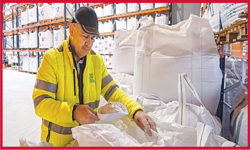 A Hoffmann Green Cement Technologies worker displays the cement made at the production site, in Bournezeau, western France. Hoffmann Green Cement Technologies produces decarbonised cement which carries a carbon footprint reportedly six times inferior to traditional variants, due to a technological breakthrough based on the cement composition and the creation of a cold manufacturing process. In addition, the company caters to 50pc of its electricity needs with its own solar panels.—AFP A Hoffmann Green Cement Technologies worker displays the cement made at the production site, in Bournezeau, western France. Hoffmann Green Cement Technologies produces decarbonised cement which carries a carbon footprint reportedly six times inferior to traditional variants, due to a technological breakthrough based on the cement composition and the creation of a cold manufacturing process. In addition, the company caters to 50pc of its electricity needs with its own solar panels.—AFP